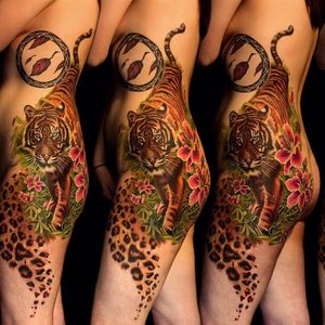 This striking tiger side piece works perfectly with his clients body. Work of Frederick Bain #FrederickBain #realism #colorrealism #tiger #leopard #flower