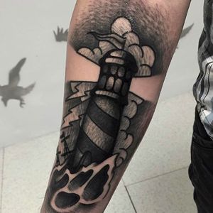 Amazing and classic lighthouse tattoo with incredible shading technique! Rad tattoo work by Andrea Raudino. #AndreaRaudino #blacktattoo #blackwork #lighthouse #traditional