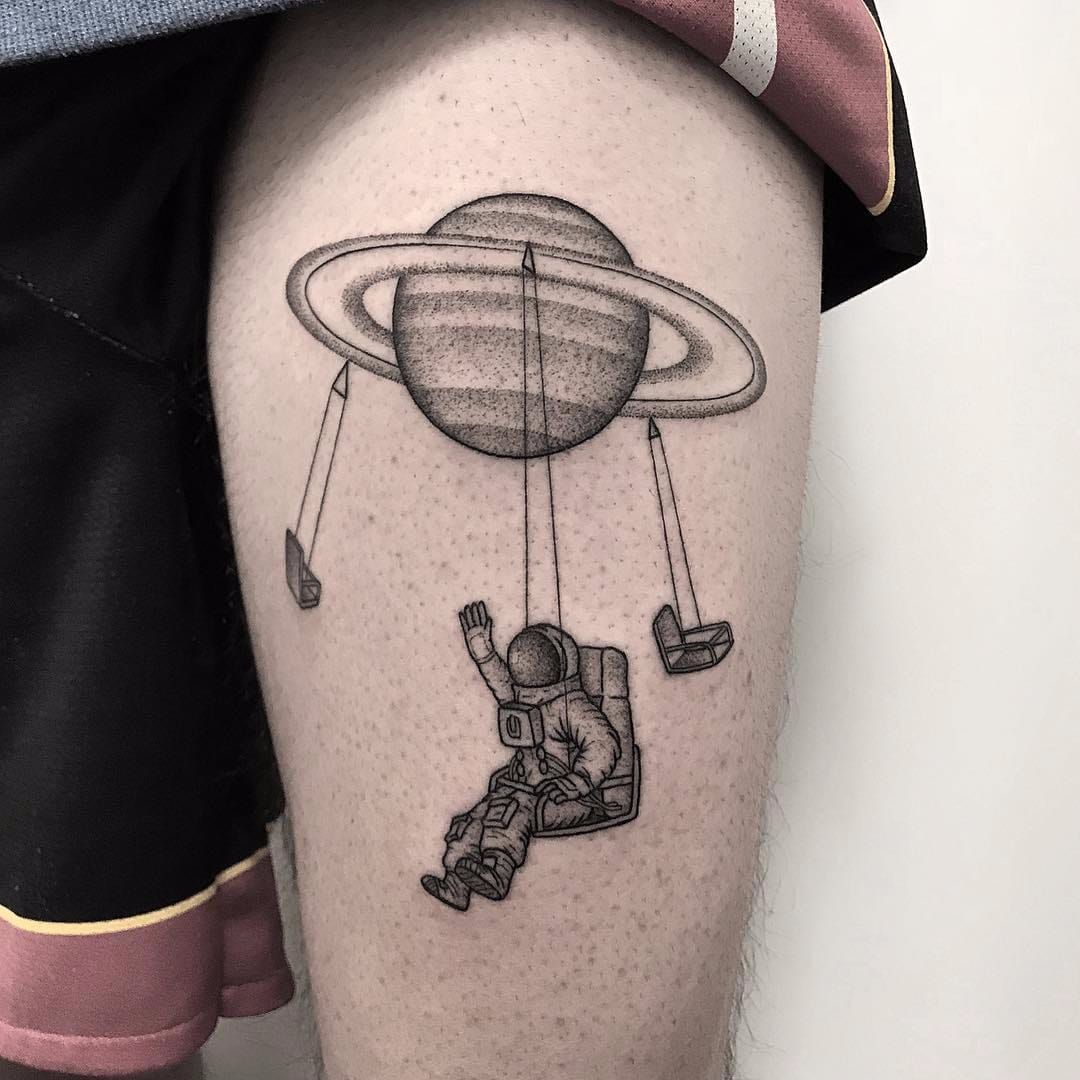 Psychedelic astronaut tattoo on the left inner forearm