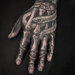 Hand tattoo by Gara #Gara #handtattoos #blackandgrey #skeleton #bones #death #snake #reptile #scales #blackfill #whiteink #anatomy