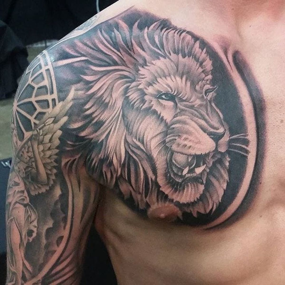Tattoo uploaded by Stacie Mayer • Black and grey lion chest piece by  dotyink. #blackandgrey #realism #dotyink #lion • Tattoodo