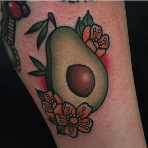 Halved avocado and flowers tattoo by Moira Ramone. #traditional #fruit #avocado #flowers #MoiraRamone