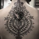 Heart gem and filigree tattoo by Alex Bawn #AlexBawn #jeweltattoos #blackandgrey #realism #realistic #folktraditional #ornamental #heart #gem #jewel #crystal #love #pattern #floral #leaves #vines #tattoooftheday