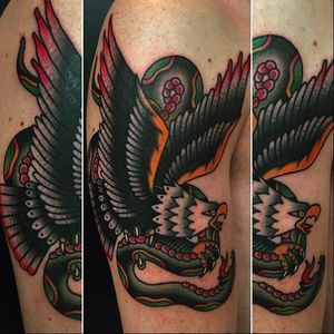 Classic looking tattoo of an eagle battling a snake. Tattoo done by Moira Ramone. #MoiraRamone #25toLife #traditionaltattoo #snake #eagle