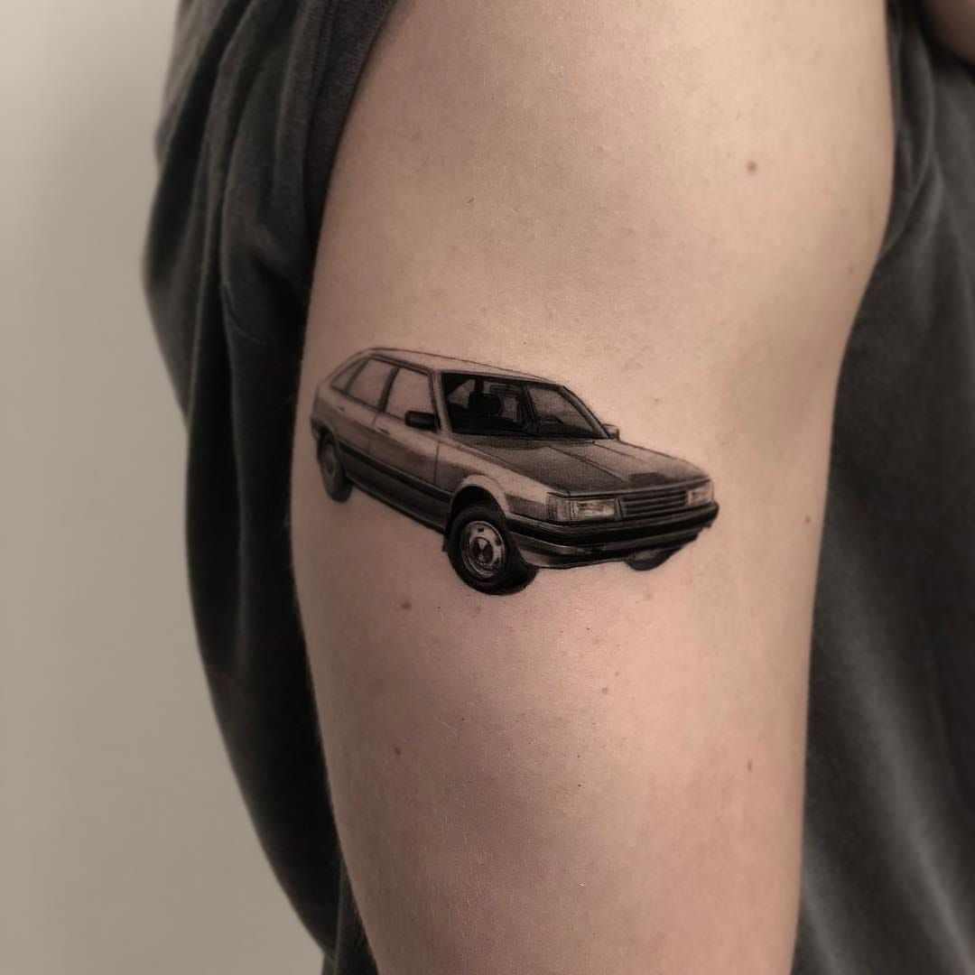 Wooden toy car tattoo on inner forearm