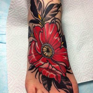 Beautiful, solid and vibrant foot flower tattoo by Evgenia Sin. #EvgeniaSin #neotraditional #coloredtattoo #foottattoo #flower #blossom