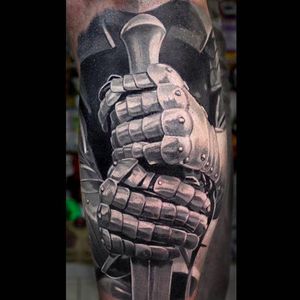 Super awesome details on this armored hands tattoo holding a sword. Tattoo by Anastasia Forman. #AnastasiaForman #realistic #blackandgray #armor #knight #sword