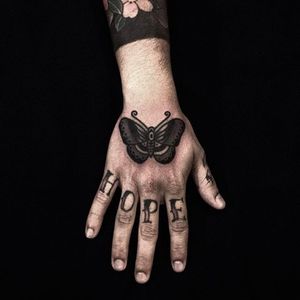 Simple yet solid butterfly hand tattoo by Andre Albuquerque. Photo: @albvquerque #andrealbuquerque #black #traditional #butterfly