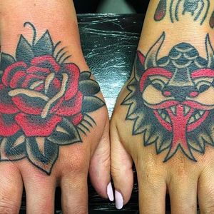 Rad pair of hand tattoos done by Janitor Jake. A demon head and a solid rose. #JanitorJake #HatCityTattoo #traditional #boldtattoos #demon #rose