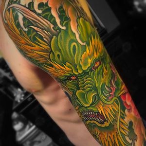 Beautiful and vibrant dragon sleeve tattoo by Chris Crooks. #chriscrooks #dragon #japanesetattoo #japanese #japanesestyle #dragonsleeve