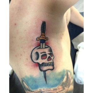 Stabbing dagger tattoo by Sebastian Garcia Herrera #SebastianGarciaHerrera #daggerthroughtattoo #skull