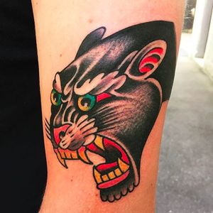 Solid and masterfully done panther head tattoo by Alex Wild. #AlexWild #traditionaltattoo #boldtattoos #panther #pantherhead