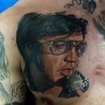 Tattoo by Dmitriy Samohin #DmitriySamohin #selftaughttattooartists #Elvis #realism #realistic #painterly #portrait #musictattoo #singer #famous #microphone #glasses #icon #ElvisPresley