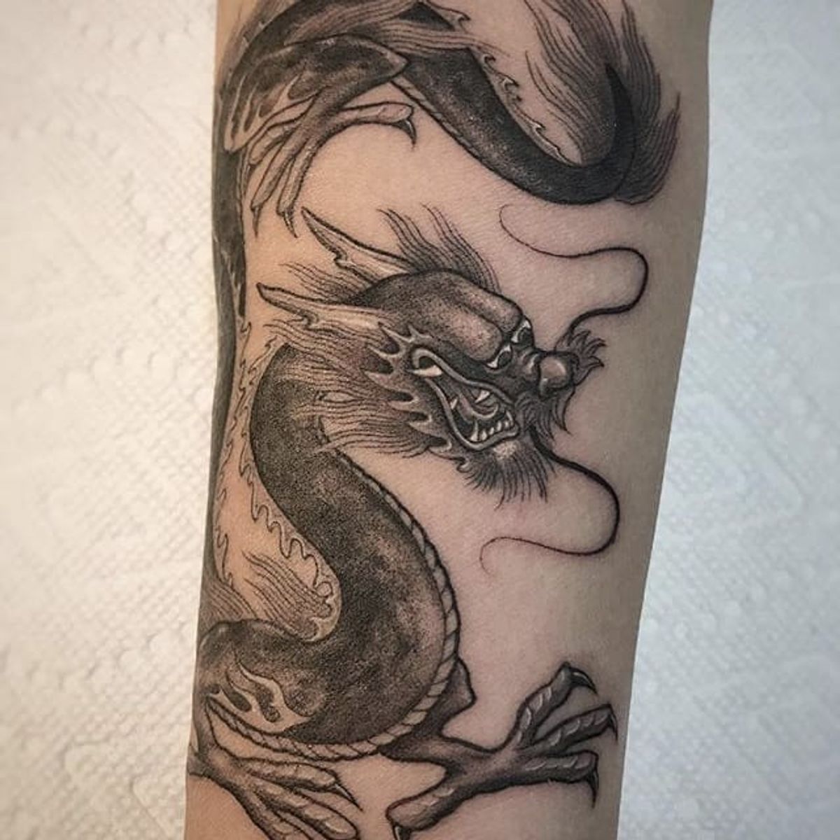 Tattoo uploaded by Tattoodo • Black and grey dragon by Ben Grillo # ...