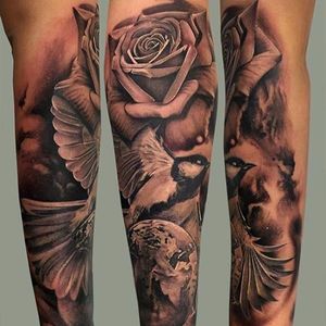 Solid rose and bird tattoo with the planet at the bottom. Solid tattoo by Massimiliano Fonzo. #massimilianofonzo #bird #rose #realistic #blackandgrey