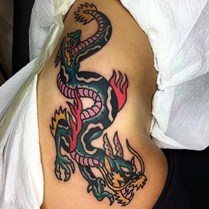 Solid and massive dragon on the side. Classic solid tattoo by Aldo Rodriguez. #AldoRodriguez #GrandUnionTattoo #traditionaltattoo #boldtattoos #dragon #classic