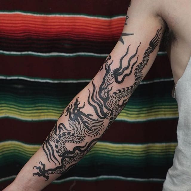 dragon tattoo wrapped around forearm