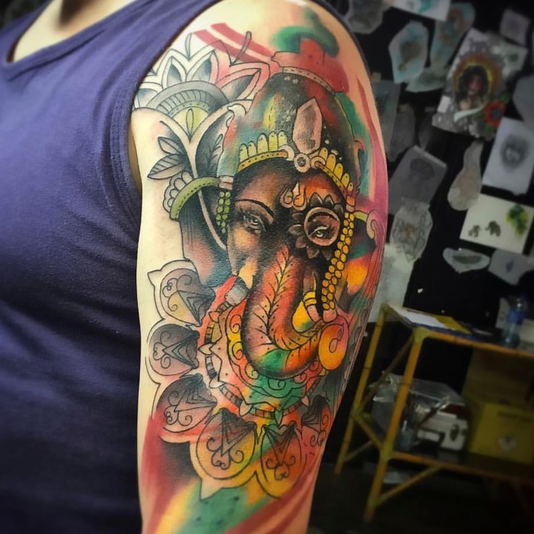 Colored Ganesha Tattoo On Side Thigh by Champion Grubbs