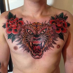 An intimidating chest-piece of a tiger bordered with roses via Marius Meyer (IG—mariusmey).  #largescale #MariusMeyer #roses #tiger #traditional