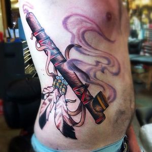 Peace Pipe Tattoo by Erik Kushner #peacepipe #pipe #smoke #feathers #NativeAmericaTattoo #traditional #ErikKushner
