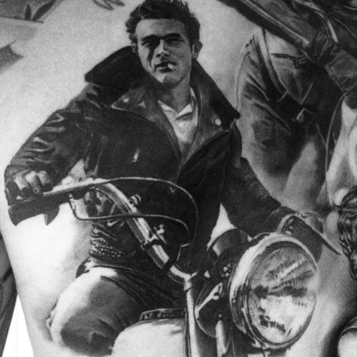 Black and grey James Dean portrait tattoo on the right