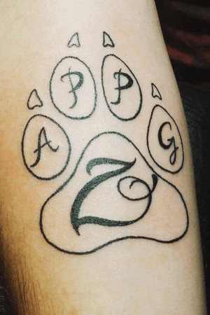My first. Pet tattoo in honor of my doggos. 