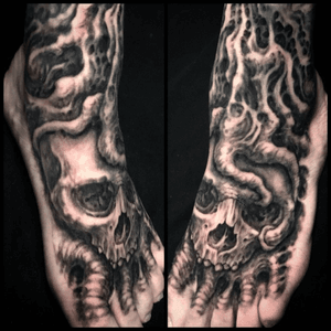 Roots with skull on the foot. All blavk and grey freehand tattoo. 