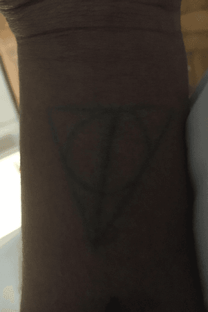 first tattoo done by random suppose to be deathly hollows symbol