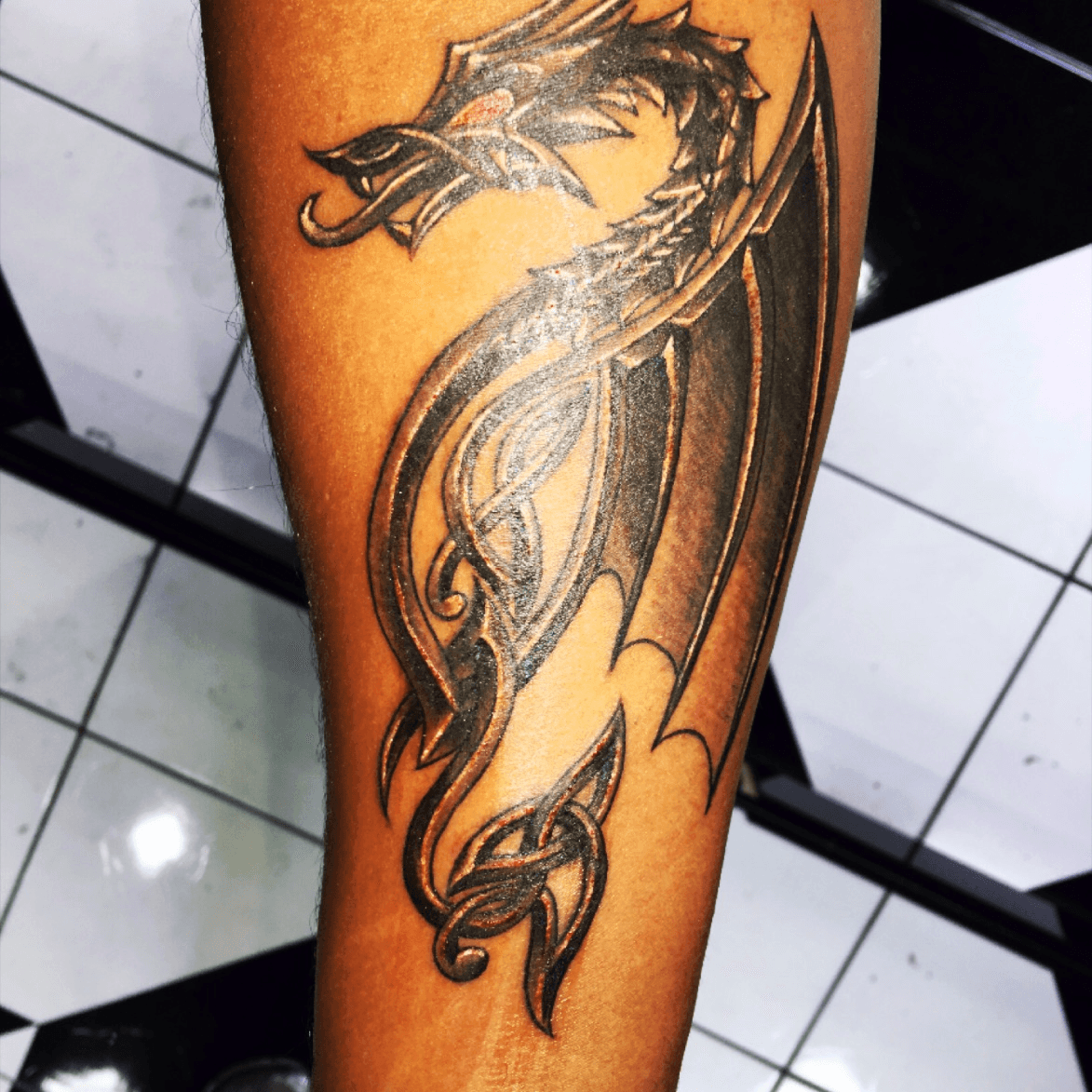 celtic dragon arm tattoo