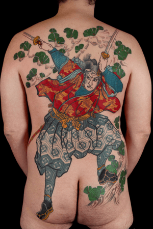 Immerse yourself in the beauty of traditional Japanese art with this stunning back piece featuring a samurai warrior and his sword, expertly done by the talented Stewart Robson.