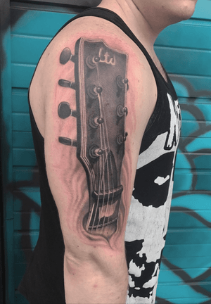 this is my first tattoo. Its a photographic image of the seven strong guitar that i have played for many a year and it has just always been helpful for me to play on it through tough times🤘🏼👌🏼🎼🎸💀🖕🏼#blackandgrey #blackandgreytattoo #realism#photograph #guitar