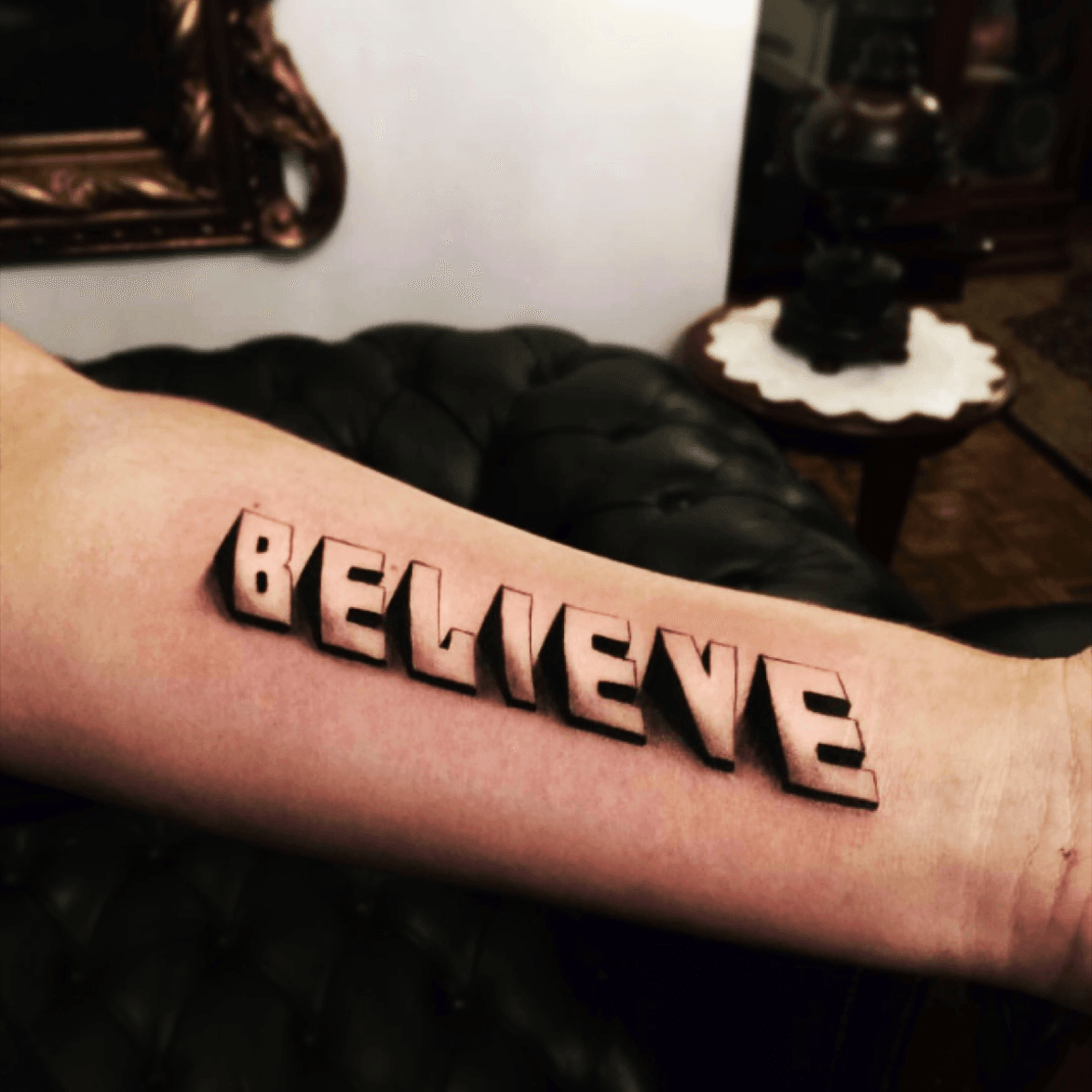 the word believe tattoo