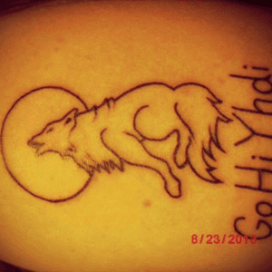 This was my first tattoo. It means "faith" in Cherokee. It also serves as a tribute to a Timber Wolf hybrid that I had once. 