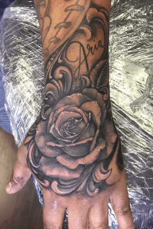 Black and grey realism rose hand tattoo 