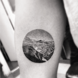 circular black and white landscape tattoo