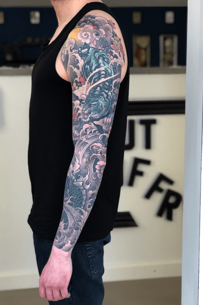Upper arm sleeve japanese tattoo with a fierce fighting rooster on