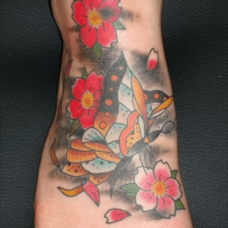 cherry blossom and butterfly foot tattoo