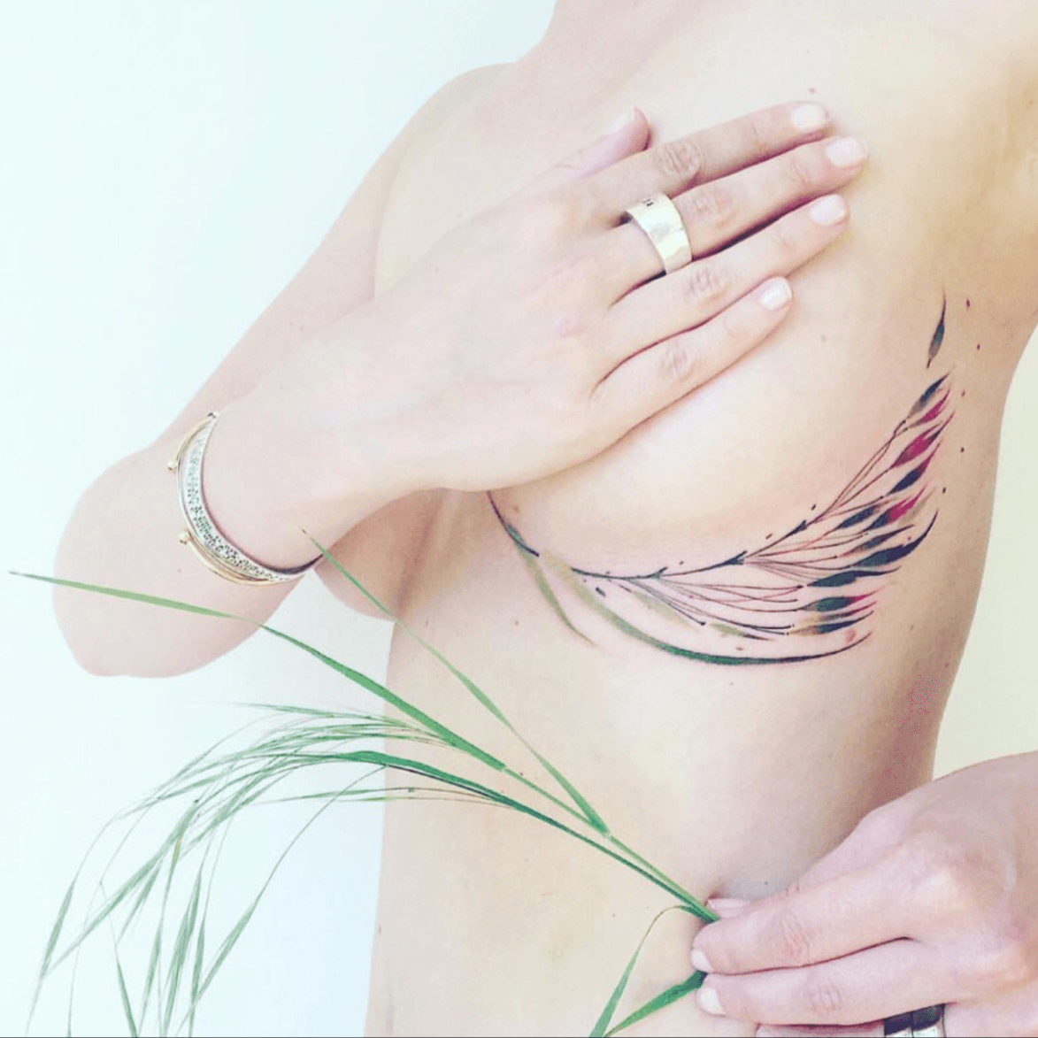 Tattoo uploaded by Tara • Beautiful! #feather #colorful #delicate #underboob  • Tattoodo