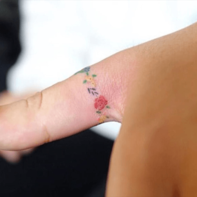 Floral ring tattoo on the right index finger