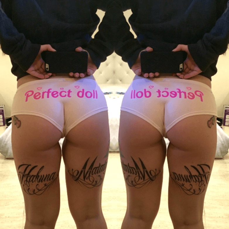 Angel Energy lettering tattoo on the butt cheek