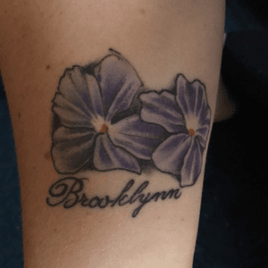 My daughters name and her birth month flower. Done at Tattoo Royal in Springfield, Ma