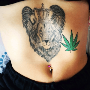 lion with crown & weed plant tattoo