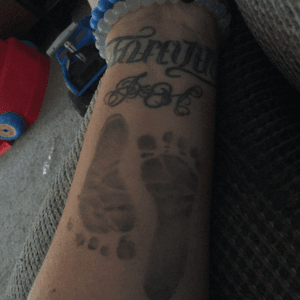 Flip script says forever and than says always  than a j and an h than my sons feet my first and second sons