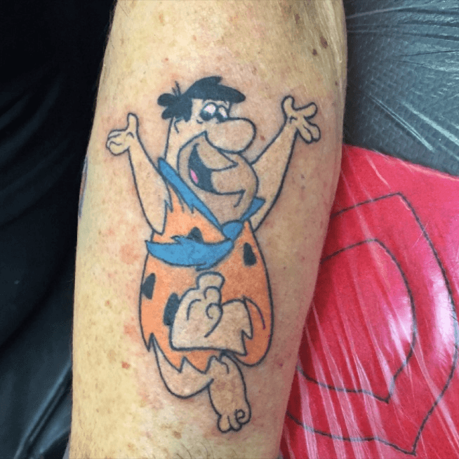 Wilma and Fred Flintstone tattoo located on the thigh