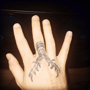 Stag tattoo on hand.