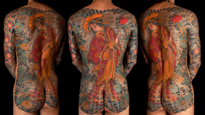 Immerse yourself in the beauty of this stunning Japanese back piece tattoo by artist Stewart Robson. Featuring intricate floral designs, a captivating geisha, and a mysterious woman.
