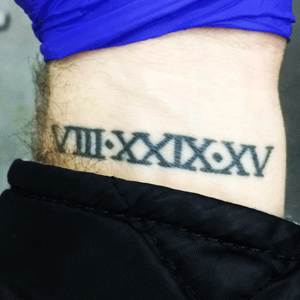 Roman numeral wedding anniversary. Was on a business trip to Kansas City and the boss gave me cash for dinners when I wasnt in training. The company I was training with took us out to dinner, so the extra cash bought me my first tattoo and a couple beers. Cheers to my asshole of an ex boss on doing one thing right. 