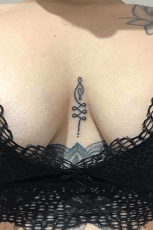Unalome tattoo between by boobs. Done by Charlotte Allen at Charlotte Tattoo. #unalometattoo #unalome #tattoo 