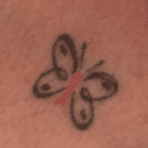 Butterfly with breast cancer pink ribbon as the body. 