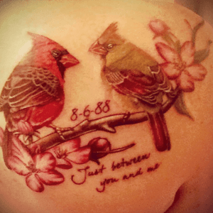 Realistic cardinals on apple blossom branch by Orville in Kansas City.